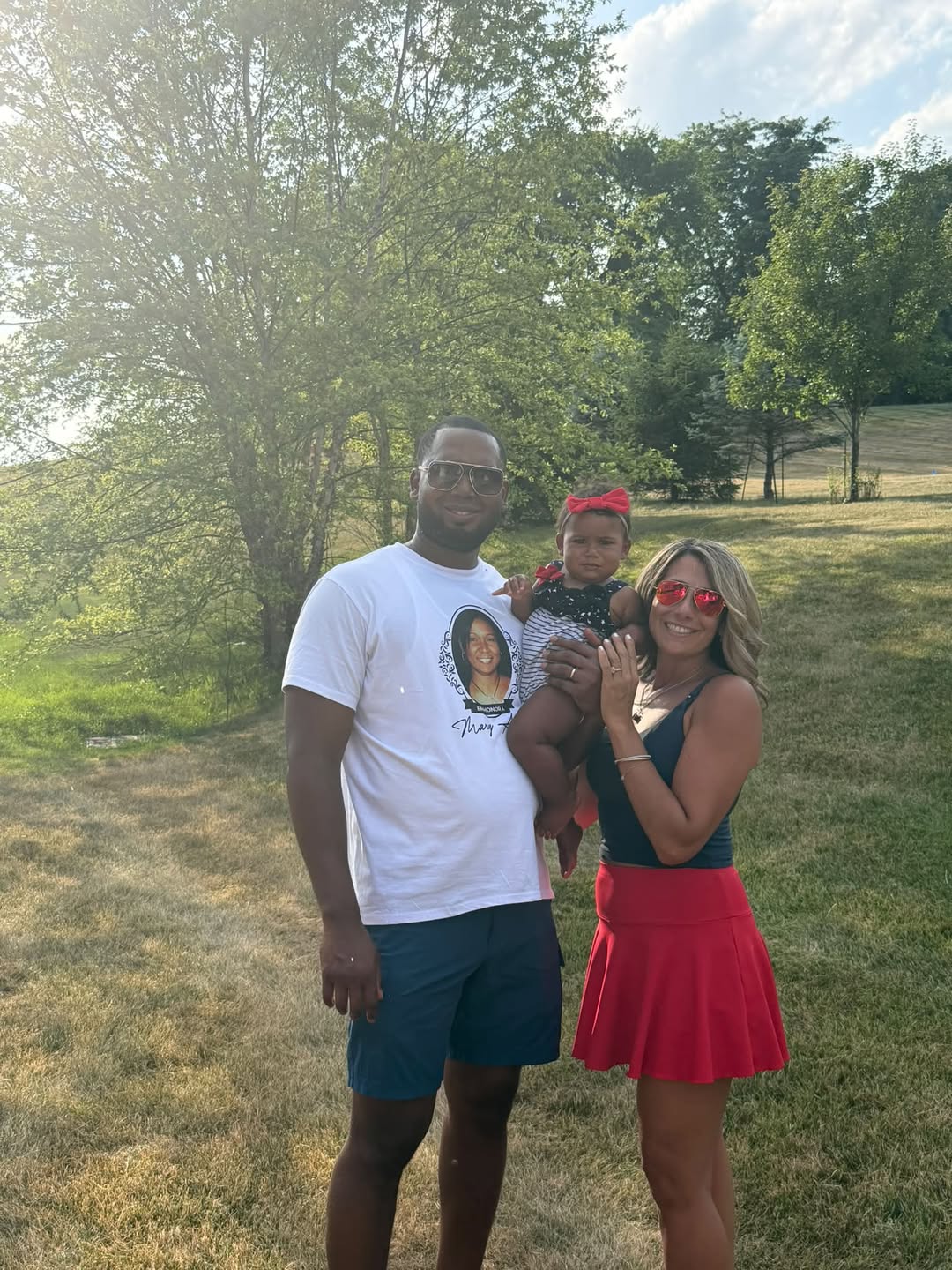 Becky with her husband and baby outside their dream home